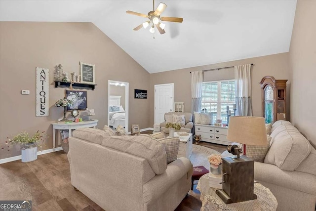 living room featuring ceiling fan, wood-type flooring, and high vaulted ceiling