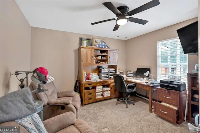 carpeted home office featuring ceiling fan