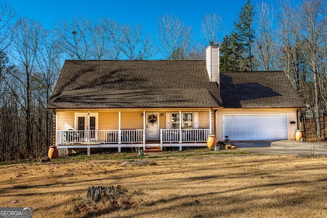 view of front facade with a garage, a front yard, and a porch