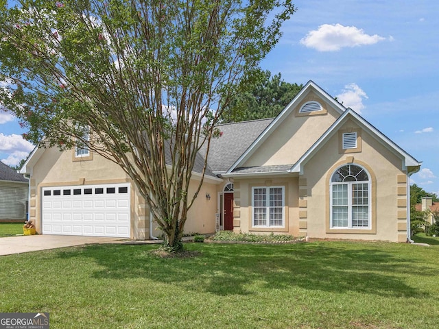 front of property with a garage and a front lawn