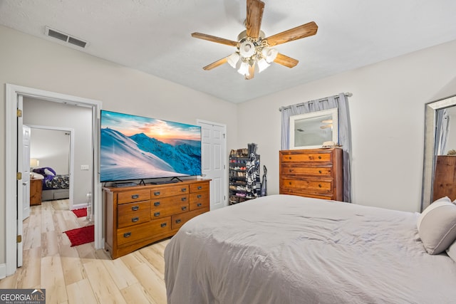 bedroom with light hardwood / wood-style flooring and ceiling fan