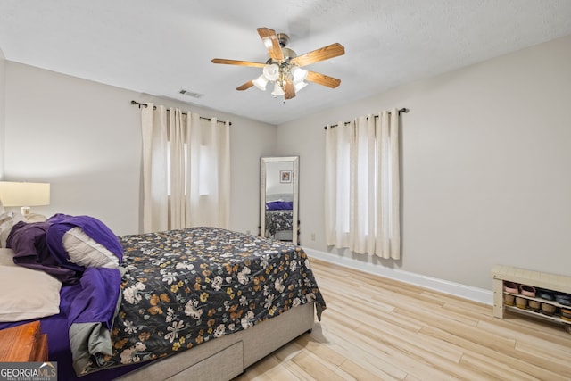 bedroom with ceiling fan and light hardwood / wood-style floors