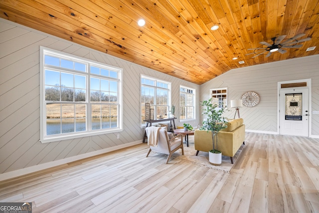 sunroom with ceiling fan, a wealth of natural light, vaulted ceiling, and wooden ceiling