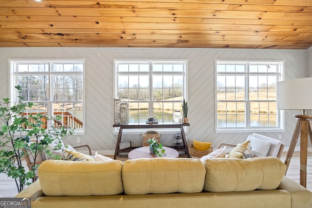 living room featuring a water view, wooden ceiling, and hardwood / wood-style flooring