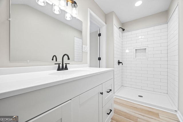 bathroom with vanity and a tile shower