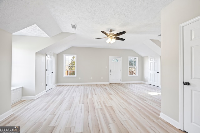 bonus room featuring vaulted ceiling, ceiling fan, a textured ceiling, and light hardwood / wood-style flooring