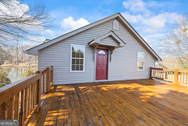 view of front facade with a deck with water view