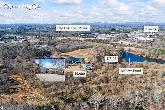 aerial view featuring a water and mountain view