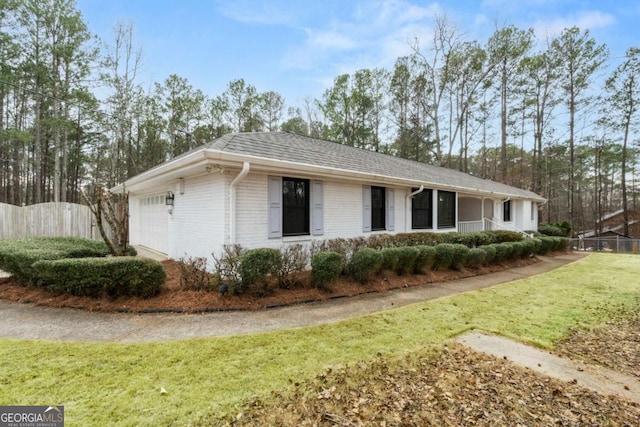 single story home featuring a garage and a front lawn