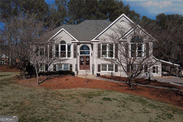 raised ranch featuring french doors and a front yard