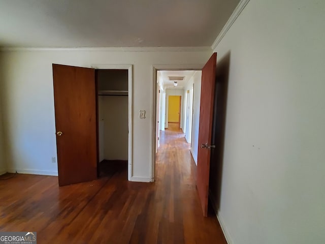 unfurnished bedroom with ornamental molding, dark hardwood / wood-style floors, and a closet