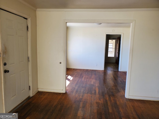 interior space featuring dark wood-type flooring and ornamental molding