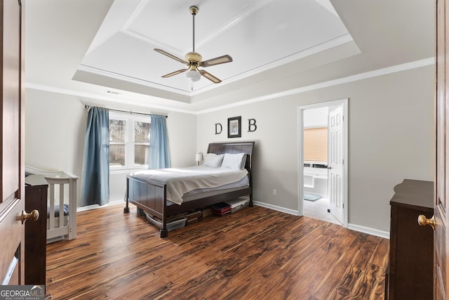 bedroom with crown molding, dark hardwood / wood-style flooring, and a raised ceiling