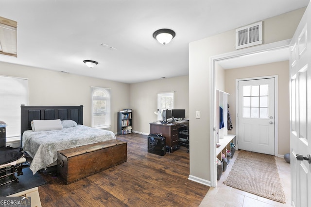 bedroom with dark hardwood / wood-style floors