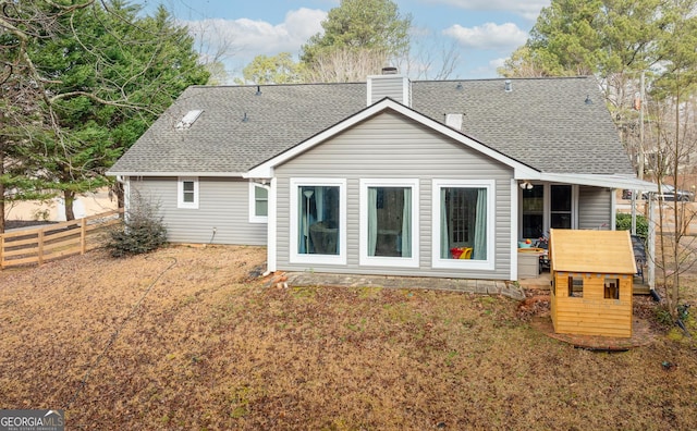 rear view of property featuring a lawn