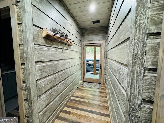 mudroom featuring wood ceiling, wood-type flooring, and wood walls