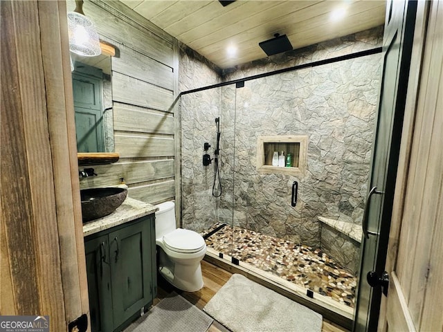 bathroom featuring wood ceiling, a shower with door, vanity, wood-type flooring, and toilet