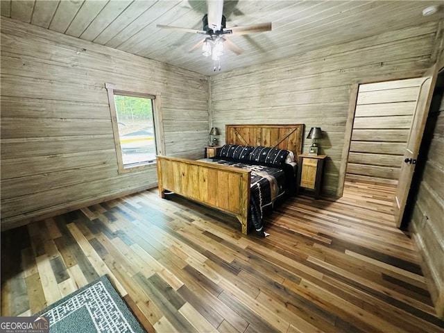 bedroom featuring dark wood-type flooring, ceiling fan, and wood ceiling