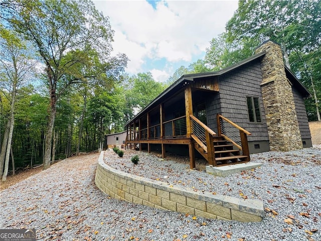 back of property featuring a wooden deck