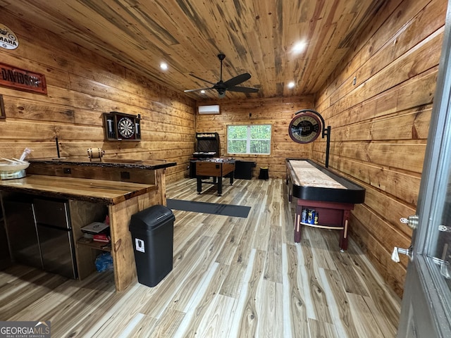 game room with wood walls, wood-type flooring, a wall mounted AC, wooden ceiling, and ceiling fan