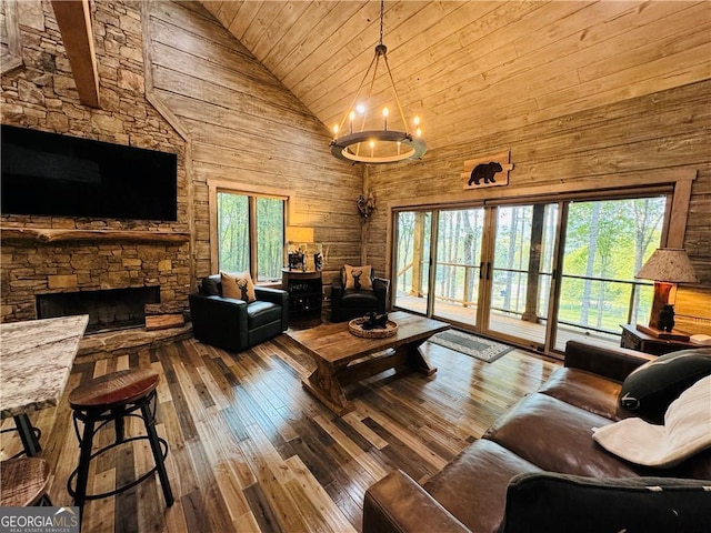 living room featuring wood ceiling, high vaulted ceiling, wooden walls, hardwood / wood-style flooring, and a fireplace