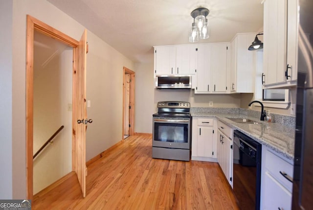 kitchen featuring sink, light hardwood / wood-style flooring, stainless steel appliances, light stone countertops, and white cabinets