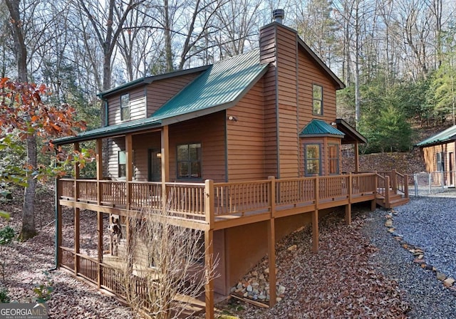 back of property featuring a wooden deck