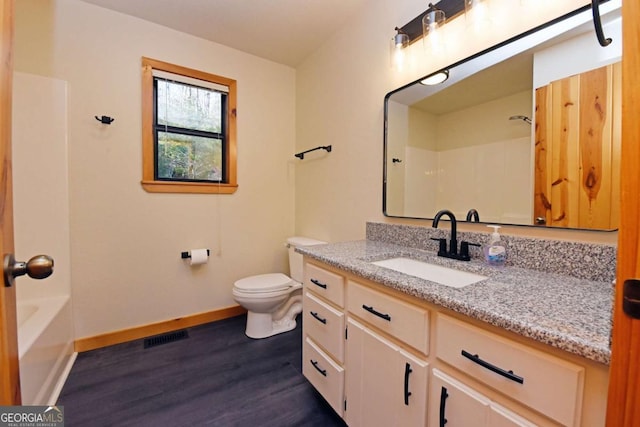 bathroom with hardwood / wood-style flooring, vanity, and toilet