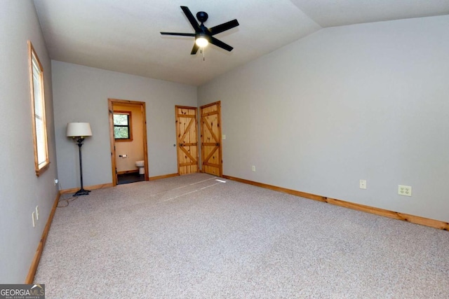 unfurnished room with lofted ceiling, carpet floors, and ceiling fan