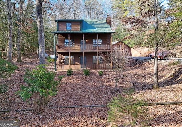 back of property with a balcony