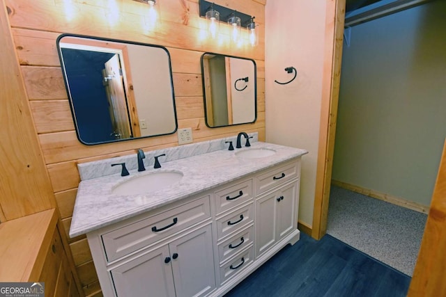 bathroom with vanity and wooden walls