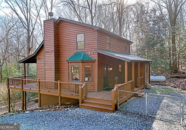 rear view of property with a wooden deck