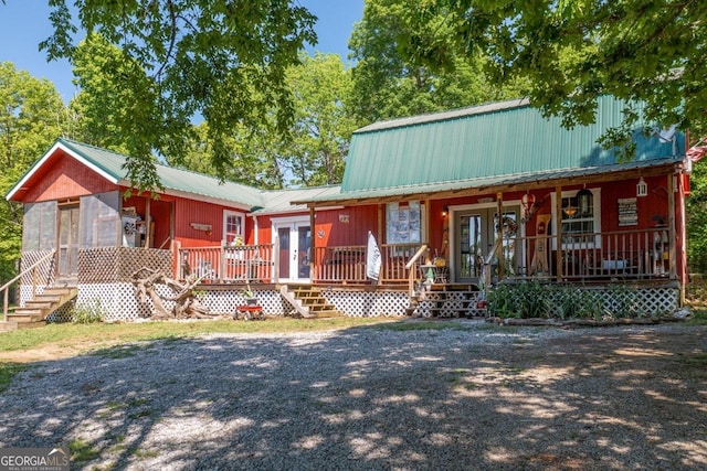 view of front of property with french doors and a porch