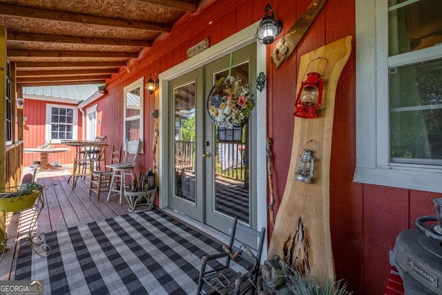 wooden deck featuring french doors and covered porch