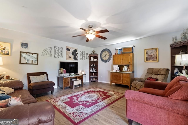 living room with light hardwood / wood-style floors and ceiling fan