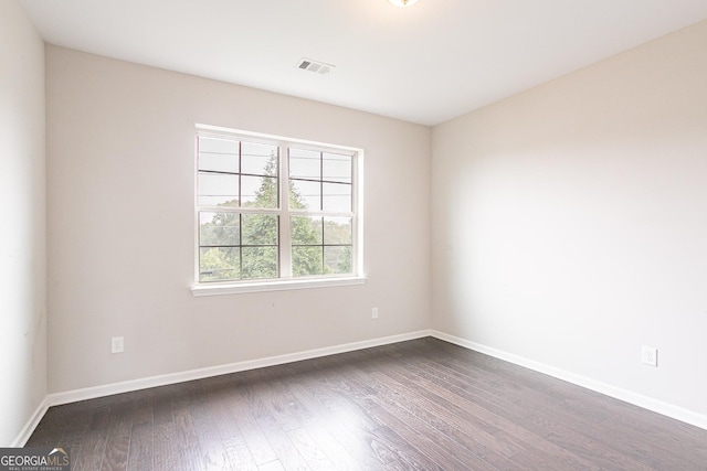 unfurnished room featuring dark hardwood / wood-style flooring