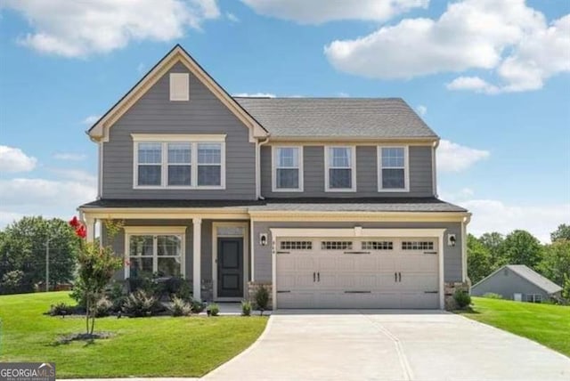 craftsman house with a garage and a front lawn