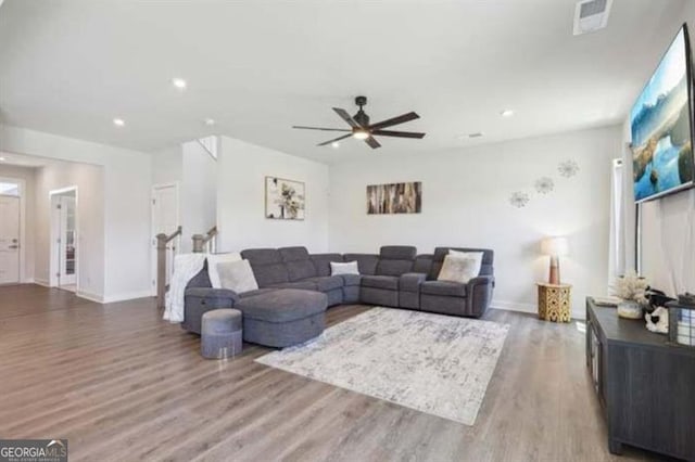 living room featuring ceiling fan and wood-type flooring