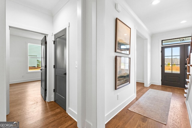 entryway featuring hardwood / wood-style flooring, ornamental molding, and french doors