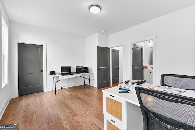 office with light hardwood / wood-style floors