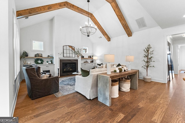 living room featuring hardwood / wood-style flooring, an inviting chandelier, high vaulted ceiling, and beamed ceiling