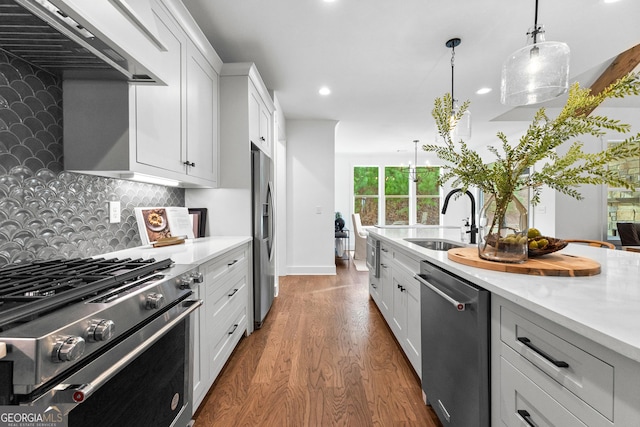 kitchen featuring sink, white cabinetry, stainless steel appliances, decorative light fixtures, and custom exhaust hood