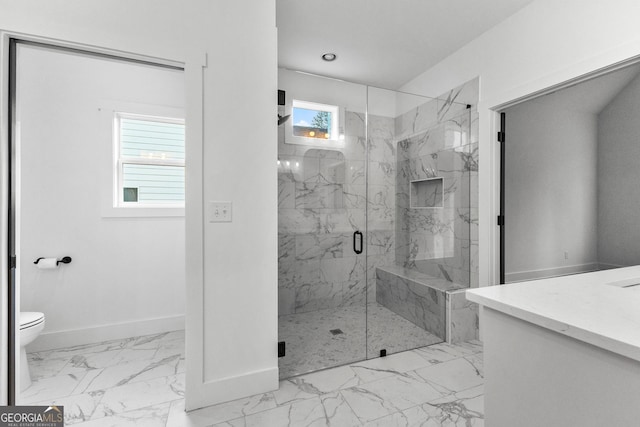 bathroom featuring vanity, a shower with shower door, and toilet