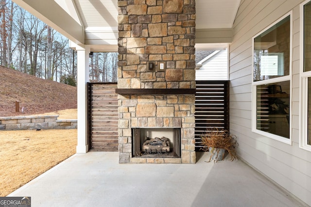 view of patio featuring an outdoor stone fireplace