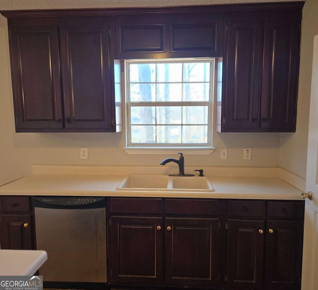 kitchen with sink, stainless steel dishwasher, and dark brown cabinetry