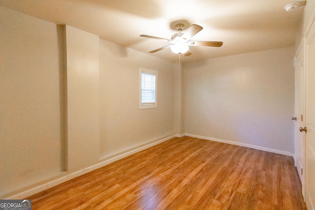 empty room featuring ceiling fan and light hardwood / wood-style floors