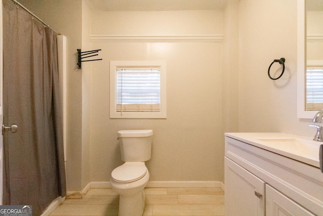 bathroom with vanity, toilet, tile patterned flooring, and plenty of natural light