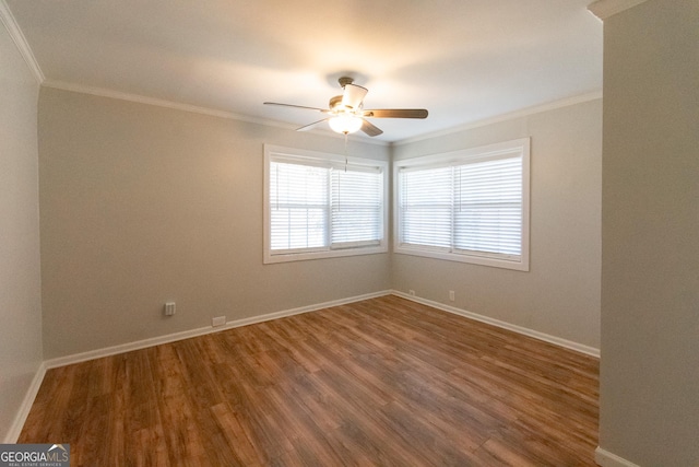 empty room with hardwood / wood-style floors, ornamental molding, and ceiling fan