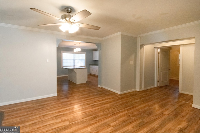 spare room featuring ornamental molding, light hardwood / wood-style floors, and ceiling fan