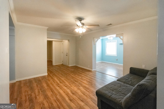 living room with ceiling fan, ornamental molding, and light hardwood / wood-style flooring